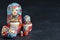 Five red matryoshka. Traditional Russian toy. Copy space. Black concrete background