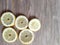Five round slices of fresh juicy lemon on a wooden table. Healthy wholesome food
