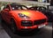 Five-seat mid-sized sports cross-over Porsche Kayenne orange in the auto show on February 05, 2020 in Russia, Kazan, Decabrists