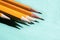 Five simple pencils blue background with copy space. selective focus