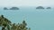 Five Sisters Islands in serene water surface. Enchanting landscape, greenery and deep calm water, Samui Thailand. Relax