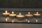 Five small candles burn and stand in a triangle. side view. Divination Halloween Mystic