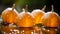 five small pumpkins with water droplets on them