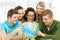 Five smiling student looking at globe at school