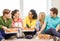 Five smiling teenagers eating pizza at home