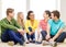 Five smiling teenagers having fun at home