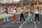 Five sports girls in a uniform training at the stadium