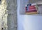 Five stacked books placed inside a space in wall in focus indoor open space white wall studio rustic stone wall in country house