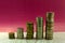 Five stacks of coins with growth between stacking limits on white background