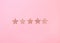 Five Star Rating on pink background. Beige glitter stars
