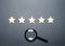 Five stars and a magnifying glass. Rating of hotels and restaurants, expensive institutions. Fame and uniqueness, attracting