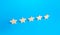 Five stars are in a row on a blue background. Rating evaluation concept. Popularity of restaurants, hotels or mobile applications