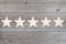 Five stars in a row on wooden planks, top rating concept