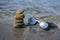 Five stones cairn tower, rock zen sculpture, brown beige pebbles and glasses