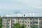 A five-storey building with a new roof replaced by a profiled sheet.