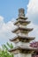 Five story stone carved pagoda against puffy clouds