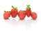 Five strawberries on a white background close-up