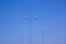 Five Street Lamps Against Bright Blue Sky
