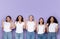 Five Surprised Diverse Ladies Pointing Fingers Upward Over Purple Background