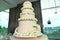 A five tier layers wedding cake creamy white in colour with white roses toppings