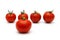 Five tomatoes with four in blur