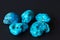 Five turquoise minerals on black background