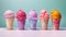 Five types of different flavors and colors of ice creams in waffle cups isolated on a bright background, copy space