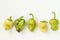 Five ugly organic bell pepper on white background, ugly food concept, horizontal photo, top view