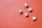 Five white dice on an orange background. Combination: square on fives