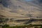 Five wind turbines on a desert hill slope