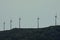 Five wind turbines on top of a mountain