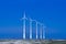 Five windmills ia a group in winter landscape