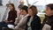 Five women sit on seminar in art studio in day time.