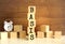 Five wooden cubes stacked vertically to form the word BASIS on a brown background.