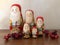 Five Wooden Santa Nesting Dolls with Berries Standing in a Group