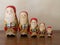 Five Wooden Santa Nesting Dolls Holding Gifts