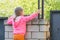 Five-year girl climbed on brick fence and looks for him