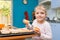 Five-year girl lays on baking tins Easter cupcakes