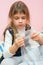 Five-year girl sitting on bed and eats bubbles packaging package