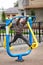 Five year old boy working out in the street, in the outdoor gym on the playground