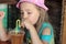 A five-year-old girl drinks lemonade in a summer cafe