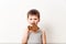 Five-year Russian boy in a gray t-shirt bites buttery pancake