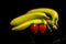 Five yellow and green banana`s and two strawberry`s