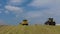 Five Yellow Tractors Tamp Silage in the Silo Trench