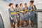 Five young elegant cheerful stewardesses chatting outdoors