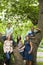 Five young friends around a tree