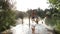 Five young friends jumping into river