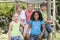 Five young friends at a playground smiling