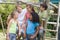 Five young friends at a playground smiling