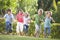 Five young friends running outdoors smiling